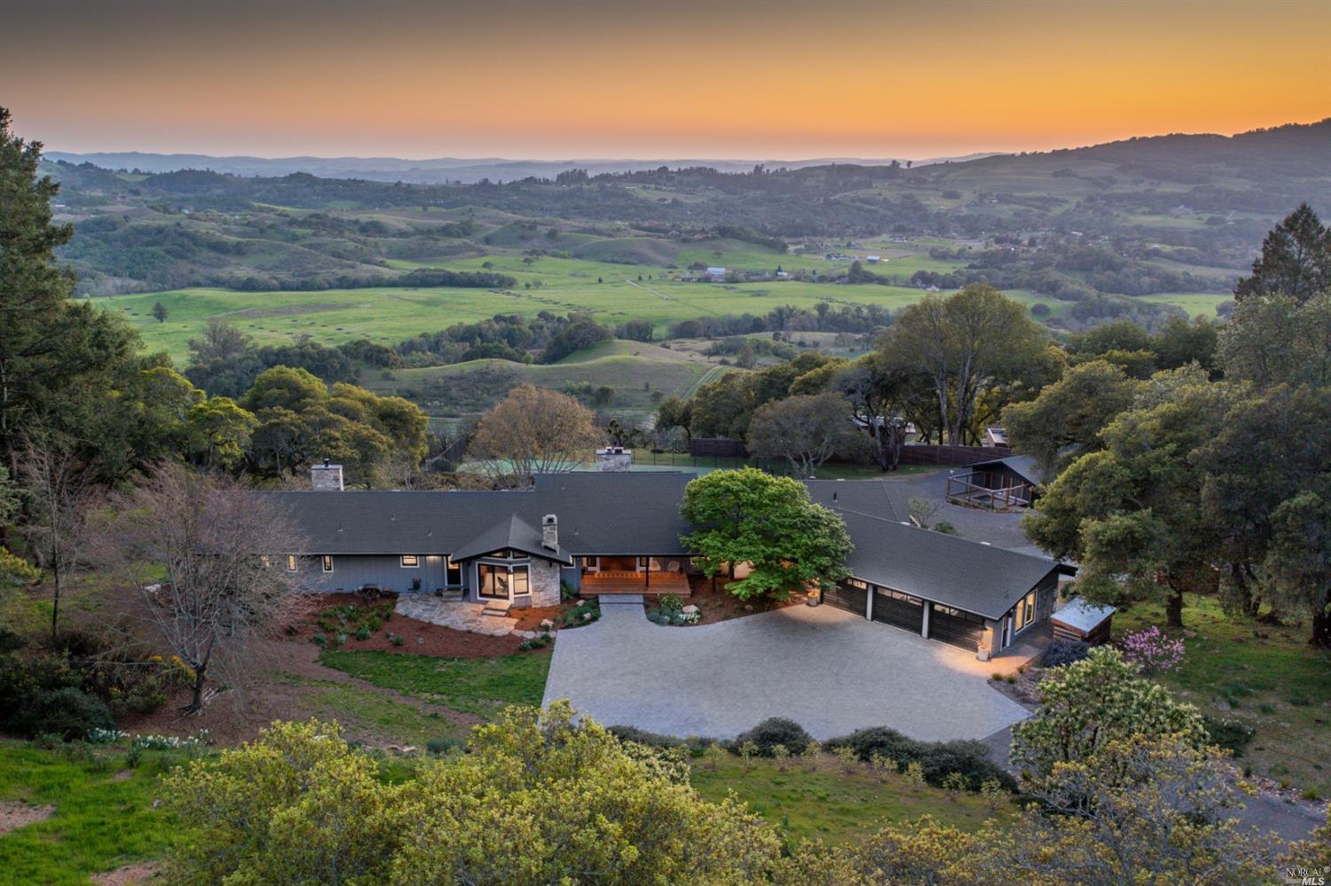 an aerial view of a house with outdoor space and lake view