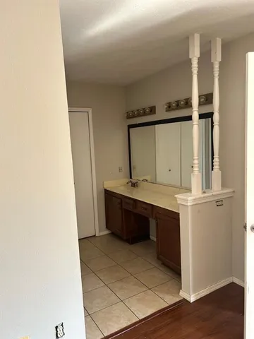 a bathroom with a bathtub sink and mirror