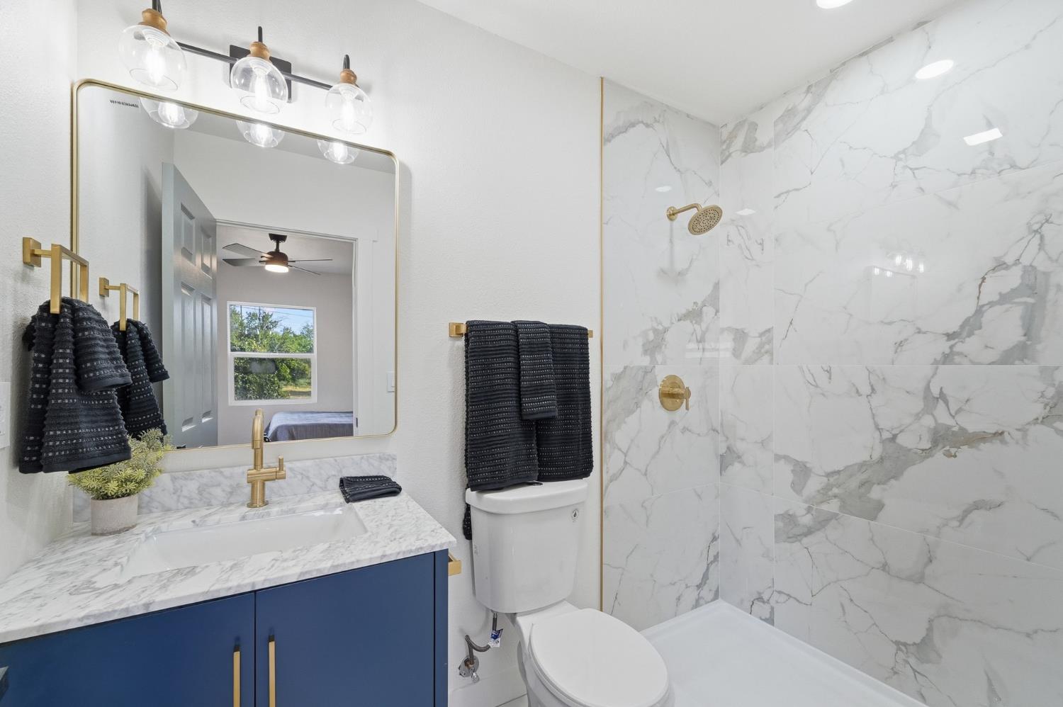 430 Laurel Avenue Modesto, CA 95351 - Photo 11 of 28 a bathroom with a granite countertop sink mirror vanity and toilet