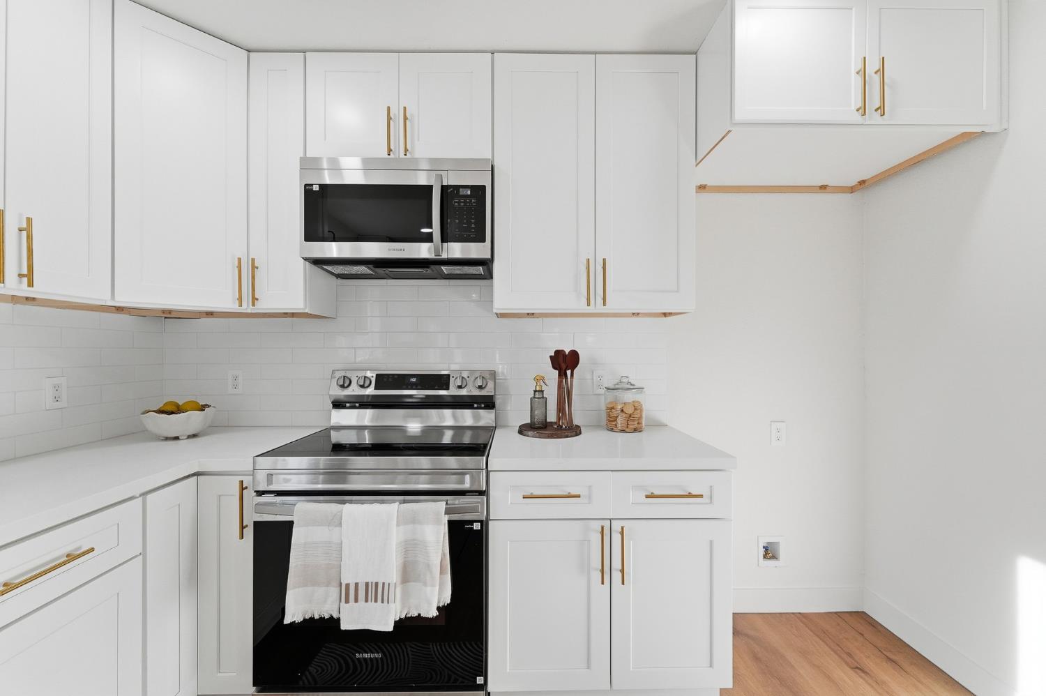 430 Laurel Avenue Modesto, CA 95351 - Photo 14 of 28 a kitchen with white cabinets and stainless steel appliances