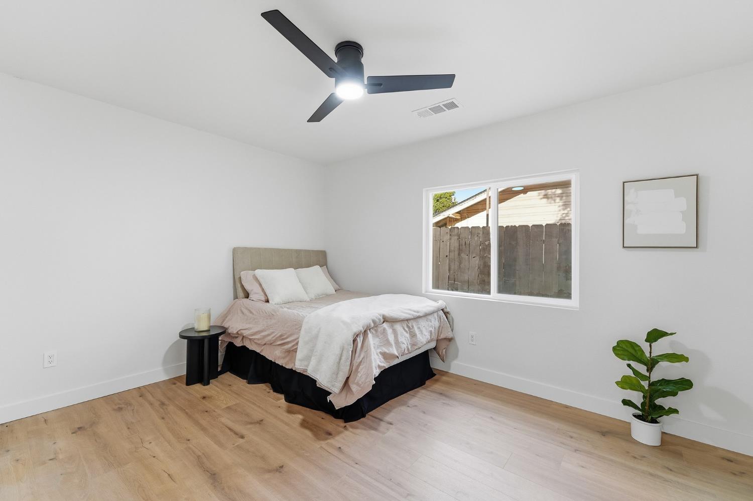 430 Laurel Avenue Modesto, CA 95351 - Photo 8 of 28 a spacious bedroom with a bed and a window
