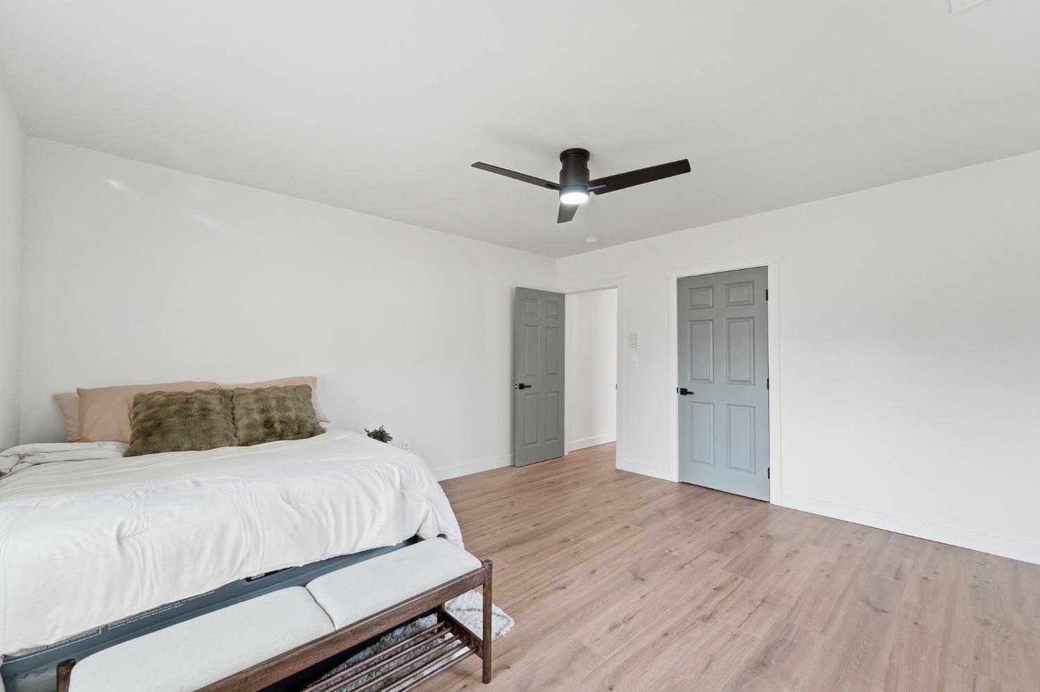 430 Laurel Avenue Modesto, CA 95351 - Photo 9 of 28 a bedroom with a large bed and a chandelier