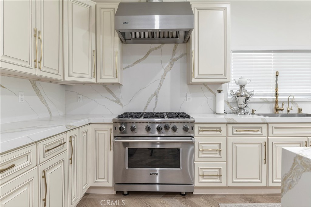 9728 Rhea Avenue Northridge, CA 91324 - Photo 12 of 36 a kitchen with granite countertop white cabinets and white stove