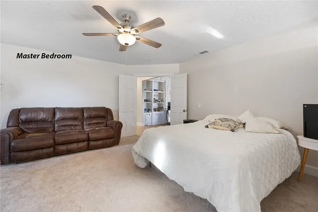 a spacious bathroom with a bathtub sink and mirror