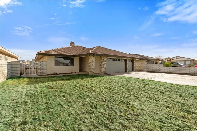 a front view of a house with a garden and yard