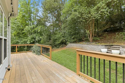 a view of balcony with deck and yard