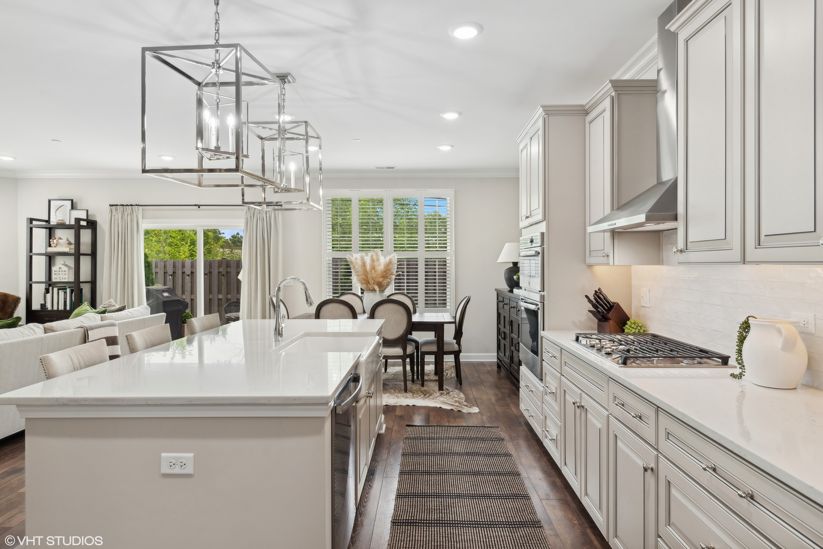 2513 Geranium Way Rolling Meadows, IL 60008 - Photo 7 of 19 a kitchen with kitchen island granite countertop a table chairs stove and white cabinets