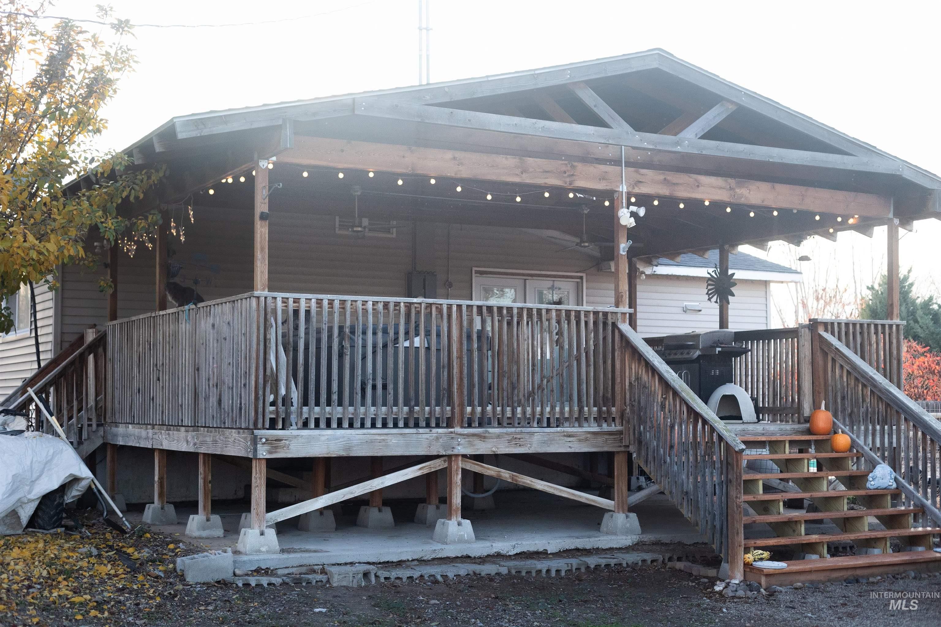 1400 Anderson Corner Road Parma, ID 83660 - Photo 21 of 31 Back of property featuring a wooden deck and stairway