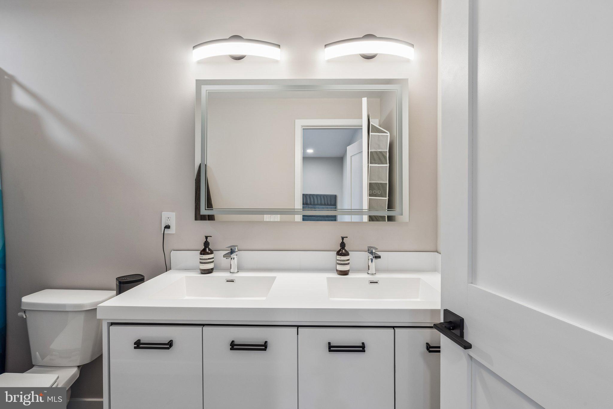 1648-50 Ridge Avenue, Unit 302 Philadelphia, PA 19130 - Photo 22 of 38 a bathroom with a sink and a toilet
