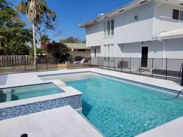 a front view of house with yard and outdoor seating