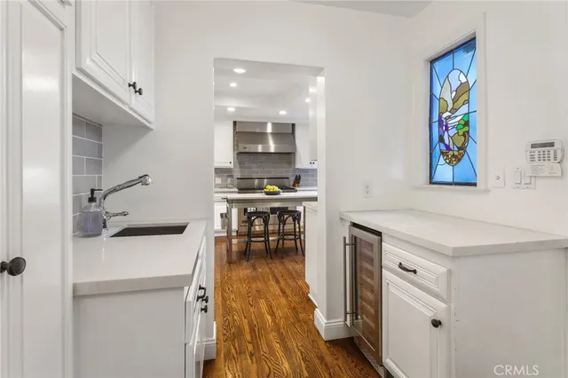 a kitchen with stainless steel appliances kitchen island granite countertop a sink and a stove top oven