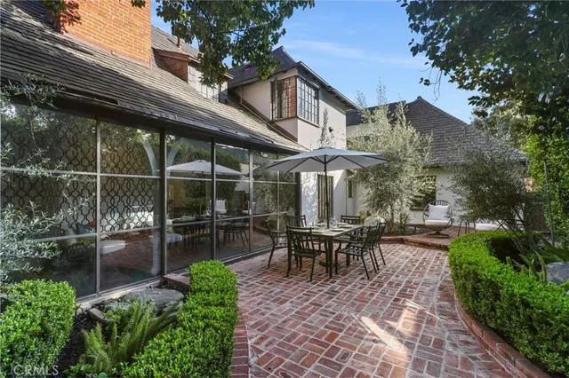 a view of a chairs and table in backyard of the house