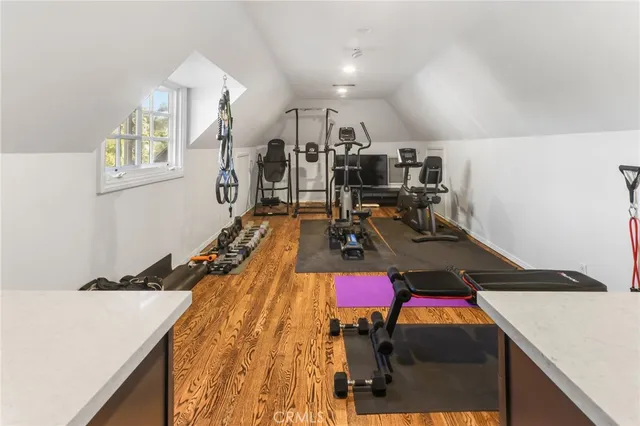 a room with gym equipment and a view of living room