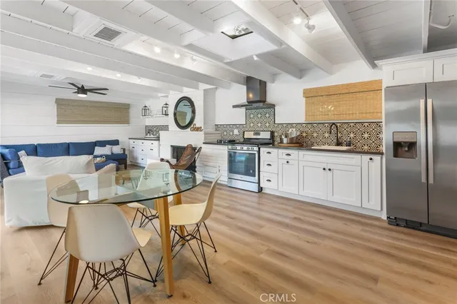 a kitchen with granite countertop a table chairs stove and cabinets
