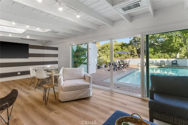 a living room with furniture and a floor to ceiling window