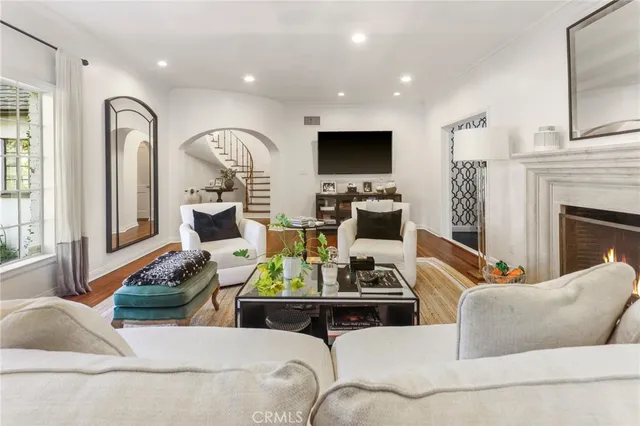 a living room with furniture fireplace and flat screen tv