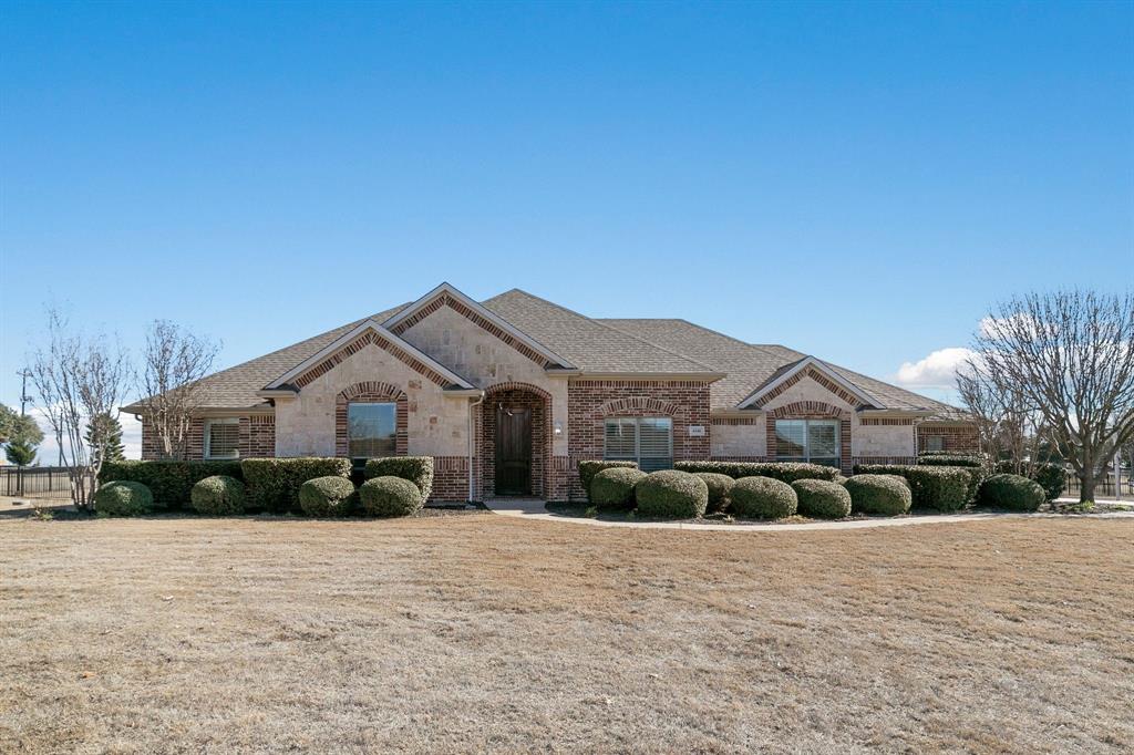 a view of a white house with a yard