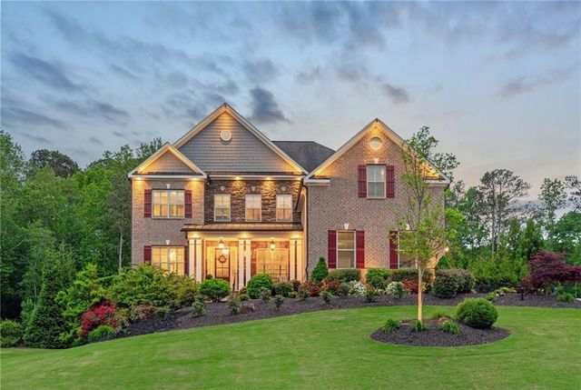 a front view of a house with a yard