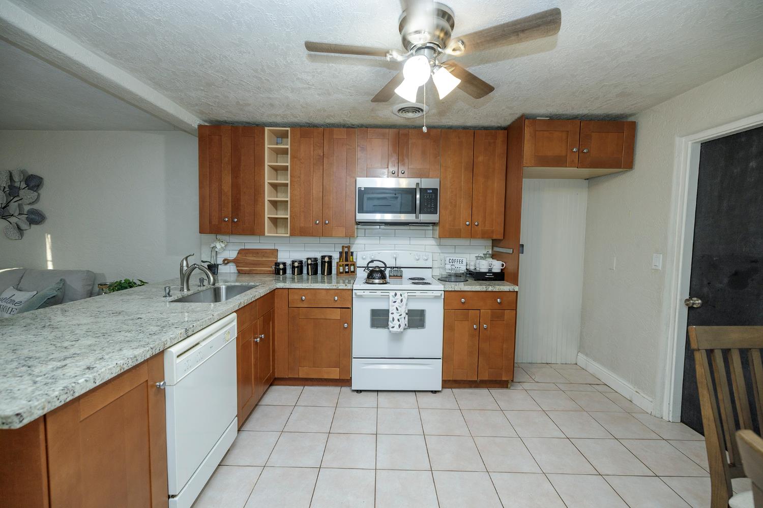 1244 Melrose Avenue Modesto, CA 95350 - Photo 13 of 39 a kitchen with stainless steel appliances granite countertop a stove a sink and a refrigerator