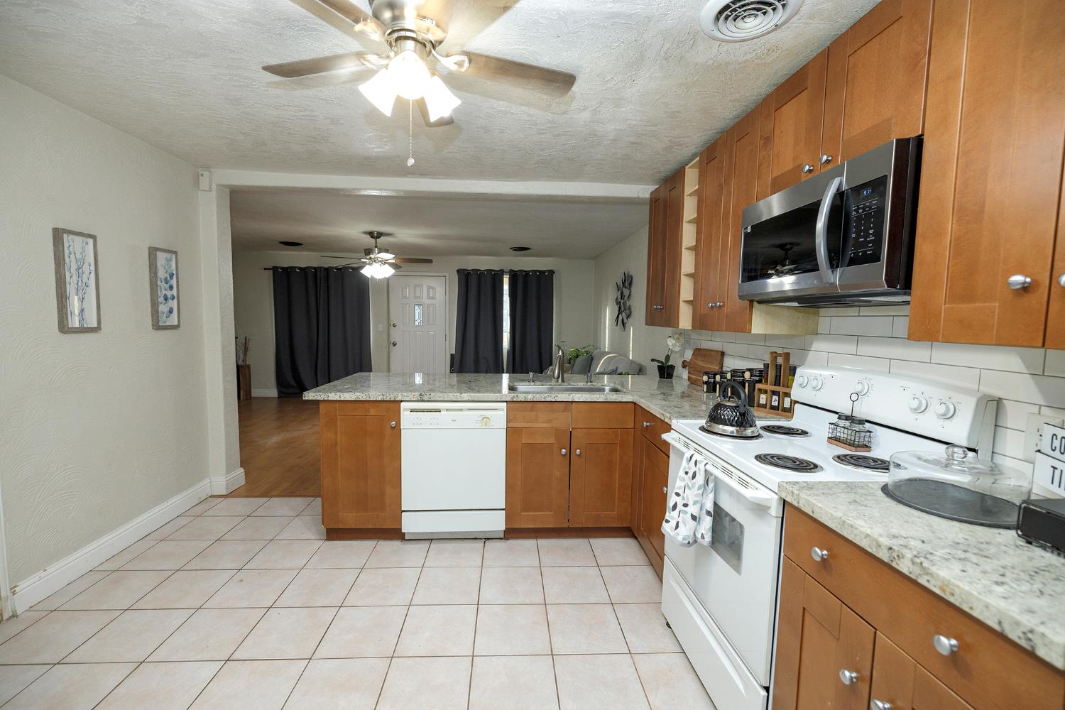 1244 Melrose Avenue Modesto, CA 95350 - Photo 14 of 39 a large kitchen with stainless steel appliances granite countertop a sink and a stove