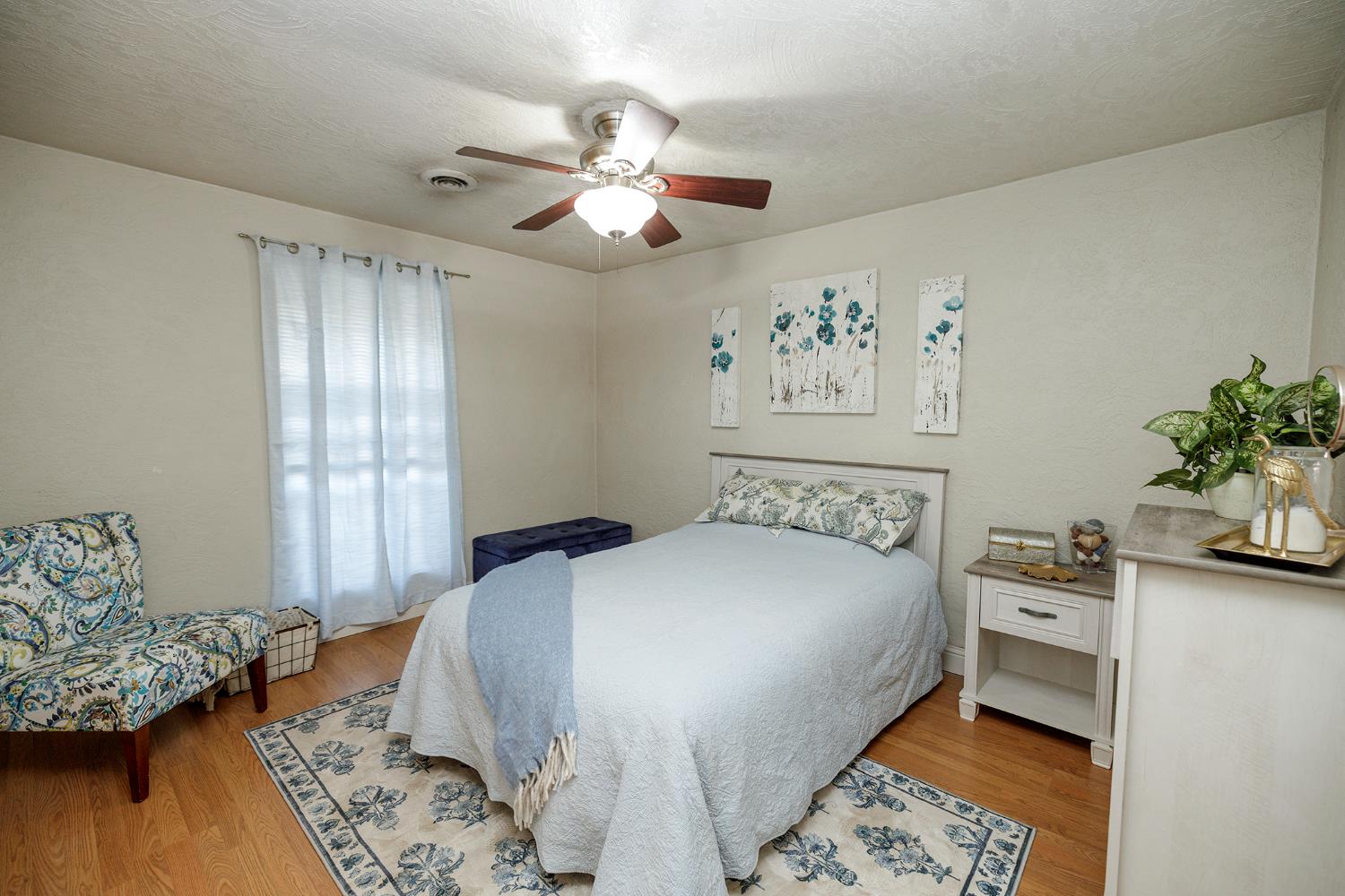 1244 Melrose Avenue Modesto, CA 95350 - Photo 16 of 39 a bedroom with a bed and a chandelier