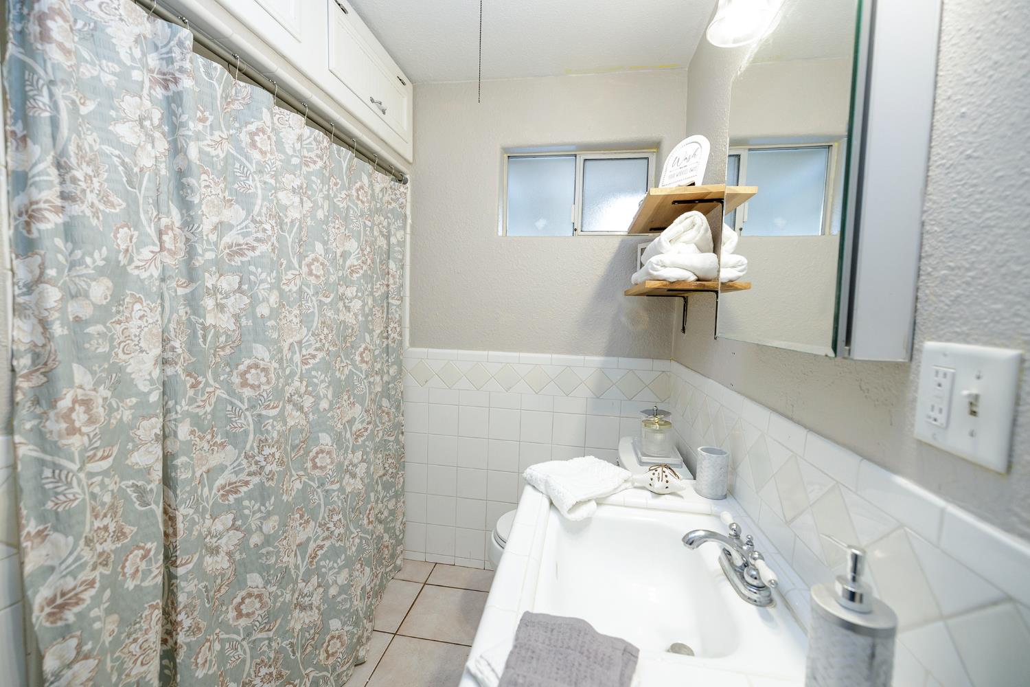 1244 Melrose Avenue Modesto, CA 95350 - Photo 19 of 39 a bathroom with a sink and mirror