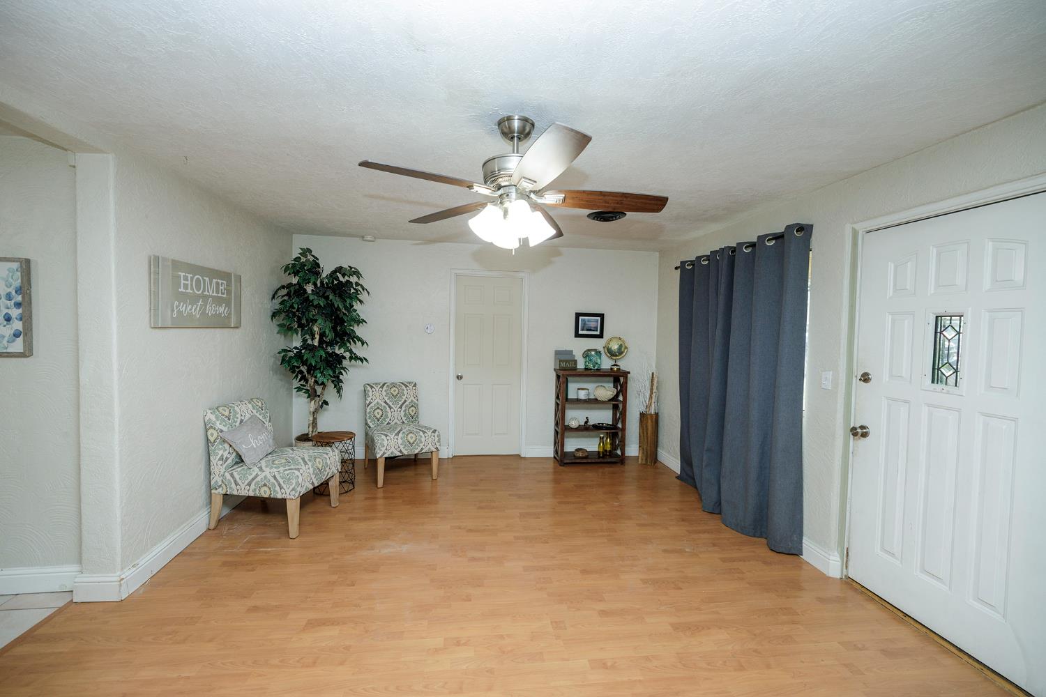 1244 Melrose Avenue Modesto, CA 95350 - Photo 9 of 39 a living room with furniture and a chandelier