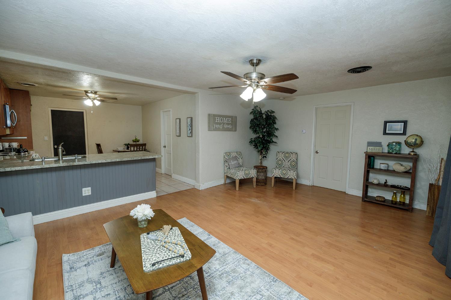 1244 Melrose Avenue Modesto, CA 95350 - Photo 10 of 39 a living room with furniture and a dining table with kitchen view
