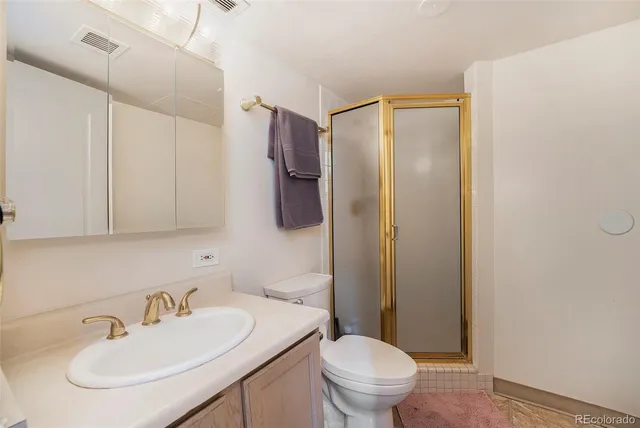 a view of hallway with closet and wooden floor