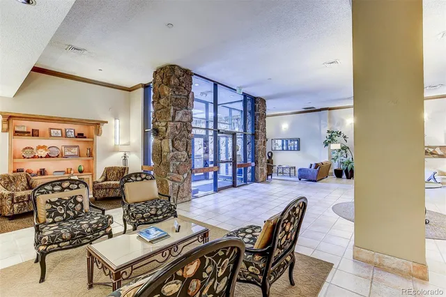 a living room with furniture a dining table and a chandelier