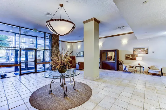 a living room with furniture and a floor to ceiling window