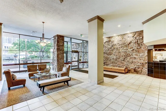 a man walking down a street next to a building