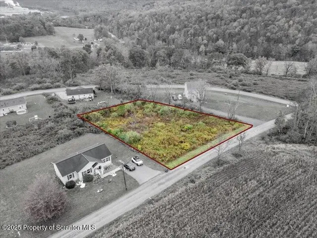 a view of a backyard with wooden fence