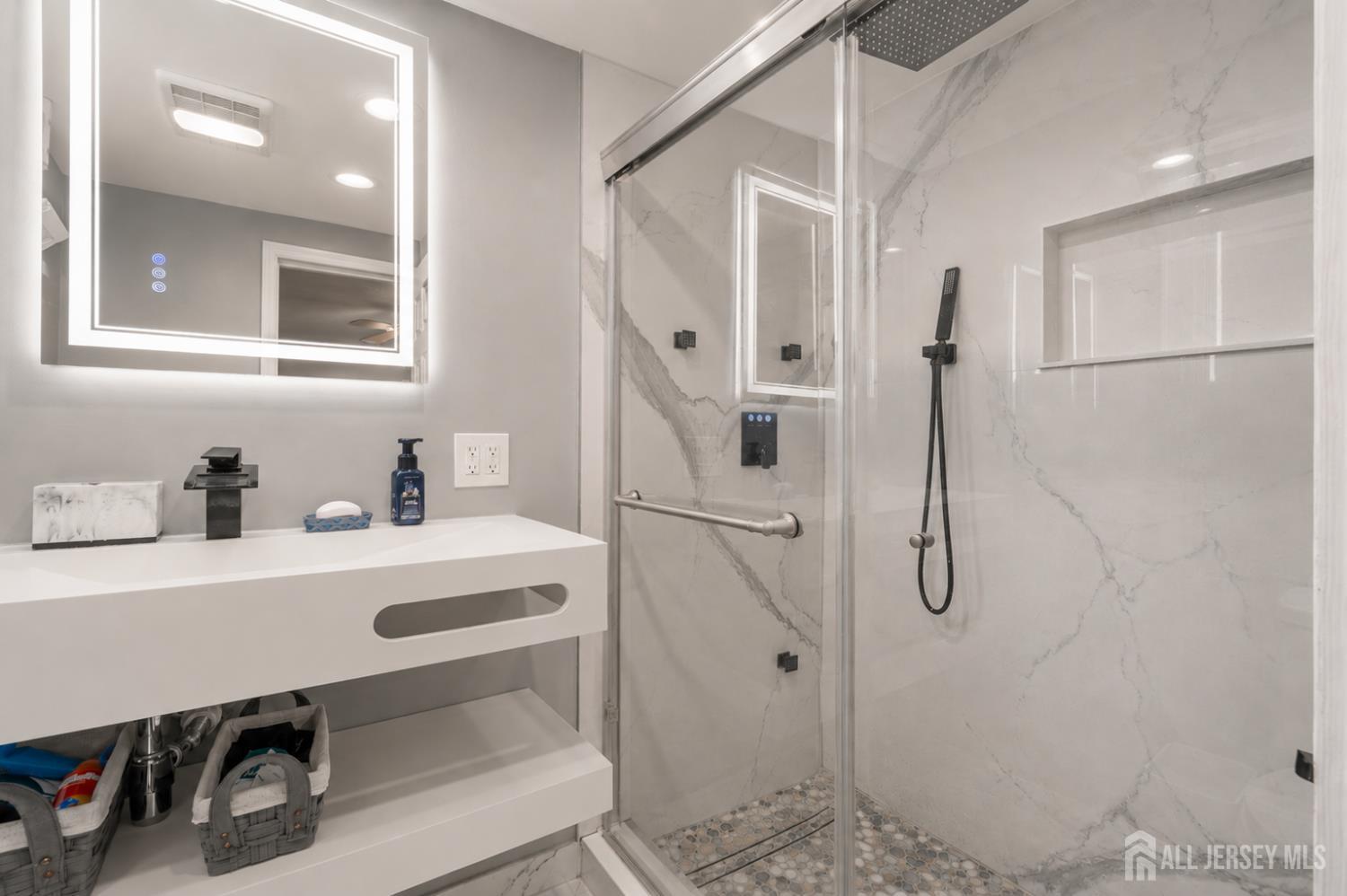 12 Pierrepont Avenue Middlesex, NJ 08846 - Photo 18 of 30 a bathroom with a sink a toilet a mirror and shower