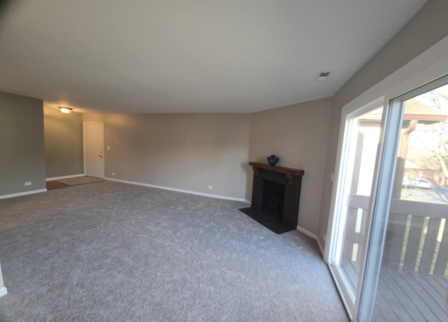 2860 Northampton Drive, Unit B2 Rolling Meadows, IL 60008 - Photo 12 of 22 a view of a hallway to a big room with wooden floor and windows