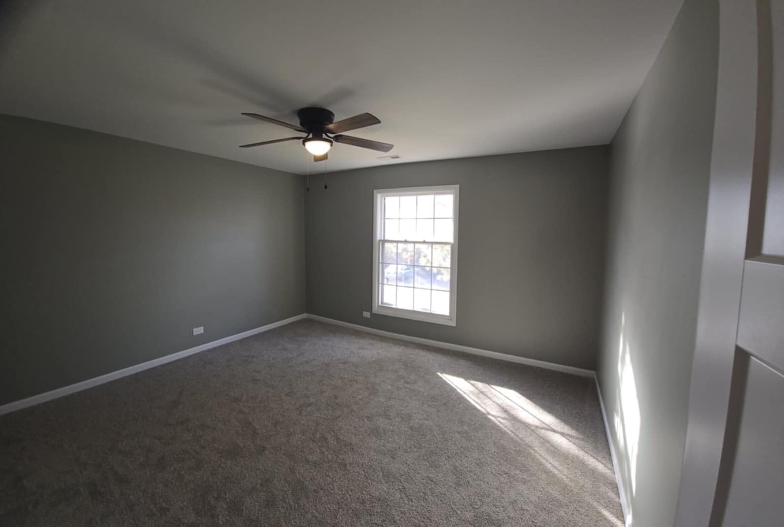 2860 Northampton Drive, Unit B2 Rolling Meadows, IL 60008 - Photo 18 of 22 an empty room with windows and fan