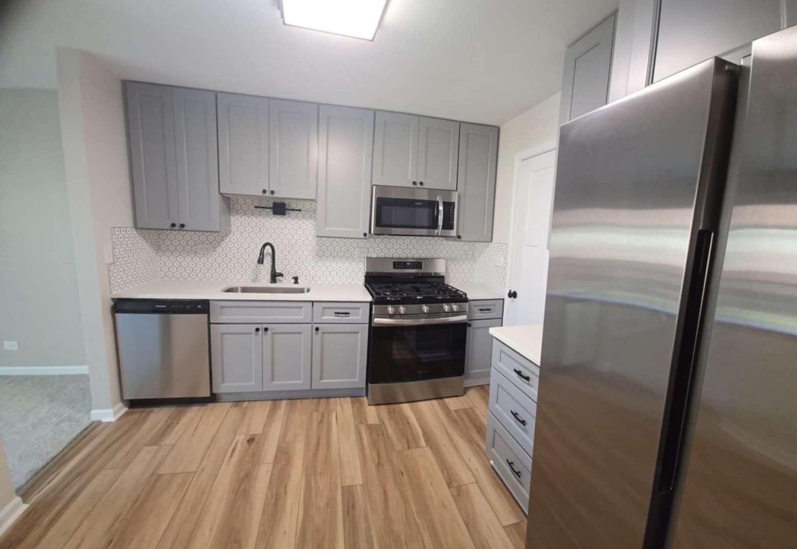 2860 Northampton Drive, Unit B2 Rolling Meadows, IL 60008 - Photo 6 of 22 a kitchen with a refrigerator stove and sink
