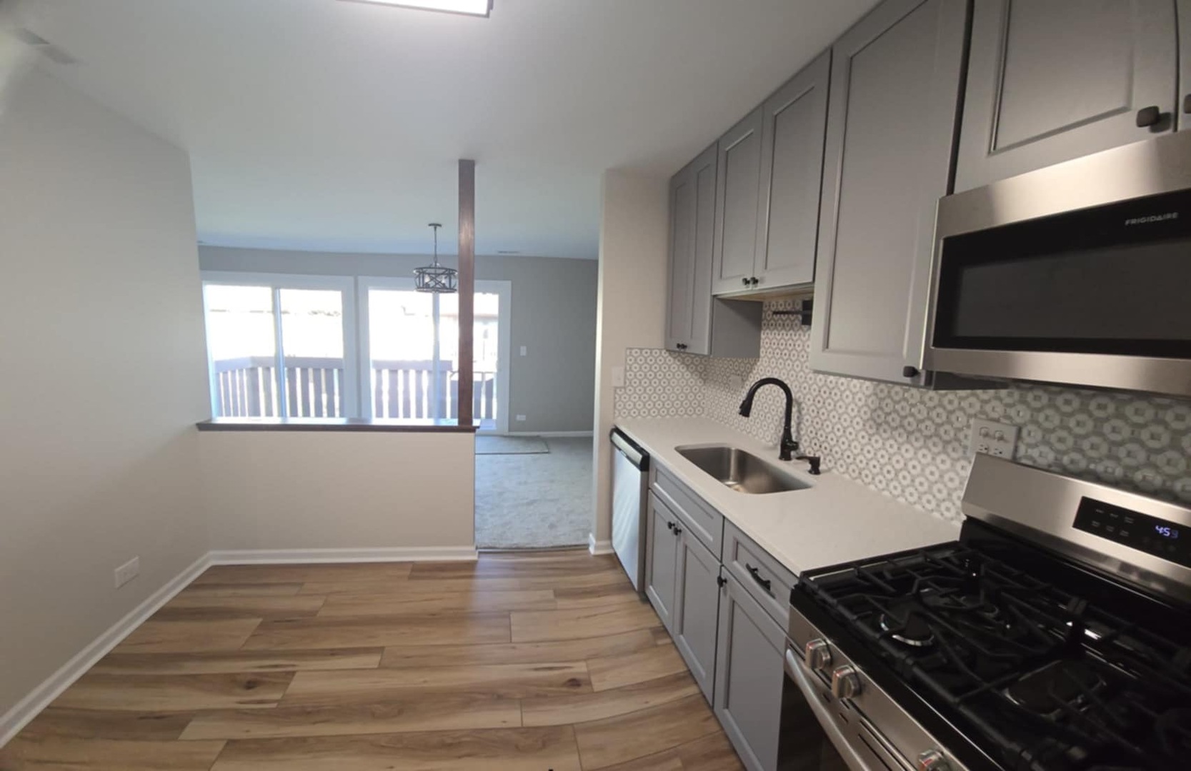2860 Northampton Drive, Unit B2 Rolling Meadows, IL 60008 - Photo 8 of 22 a kitchen with stainless steel appliances granite countertop a sink stove and cabinets