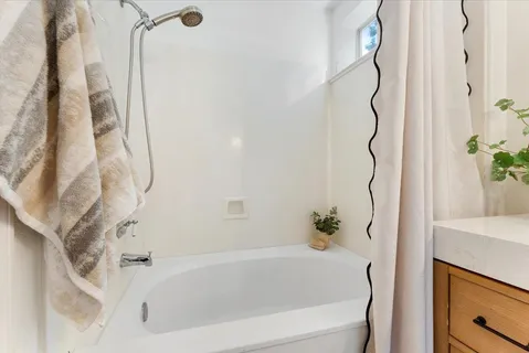 a bathroom with a bathtub and shower
