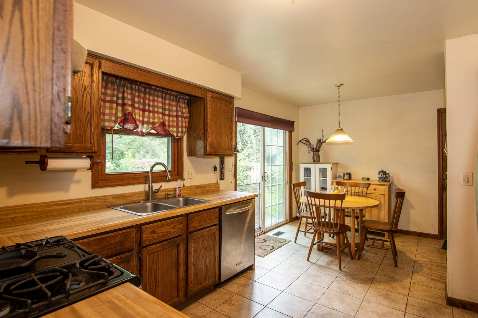 1610 South Tyler Road St. Charles, IL 60174 - Photo 3 of 16 a kitchen with a sink and chairs