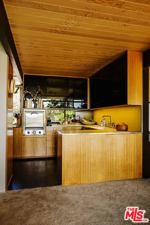 a living room with a flat screen tv and floor to ceiling window