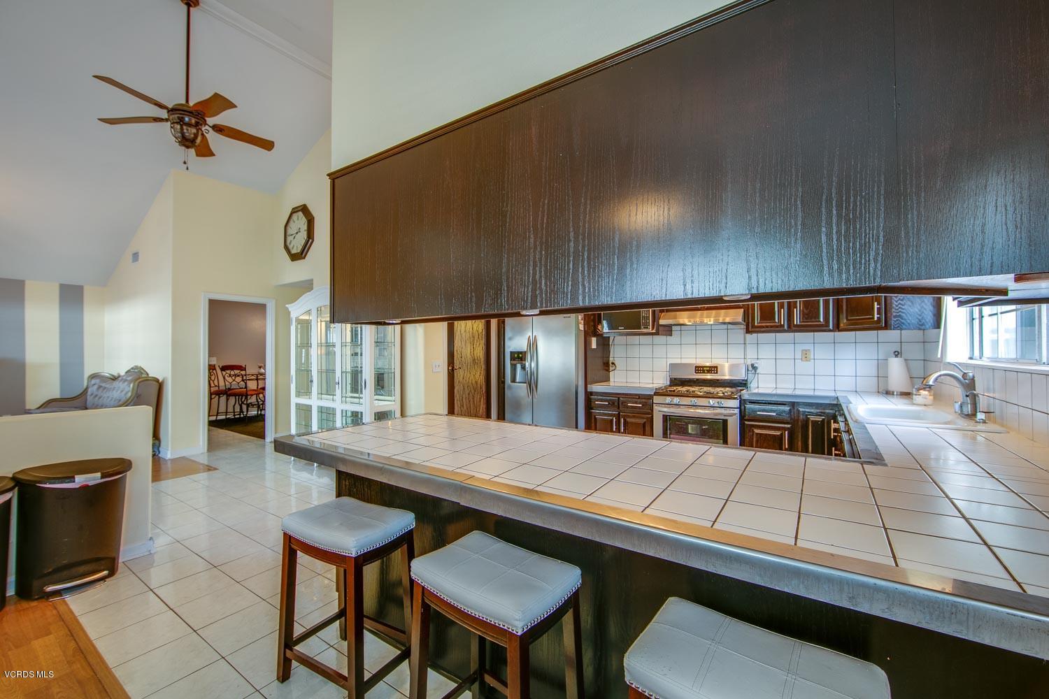 4265 Apricot Road Simi Valley, CA 93063 - Photo 11 of 39 a kitchen with a table chairs and a stove