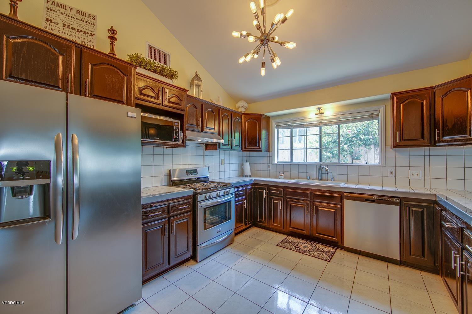 4265 Apricot Road Simi Valley, CA 93063 - Photo 12 of 39 a kitchen with stainless steel appliances granite countertop a sink and stove top oven