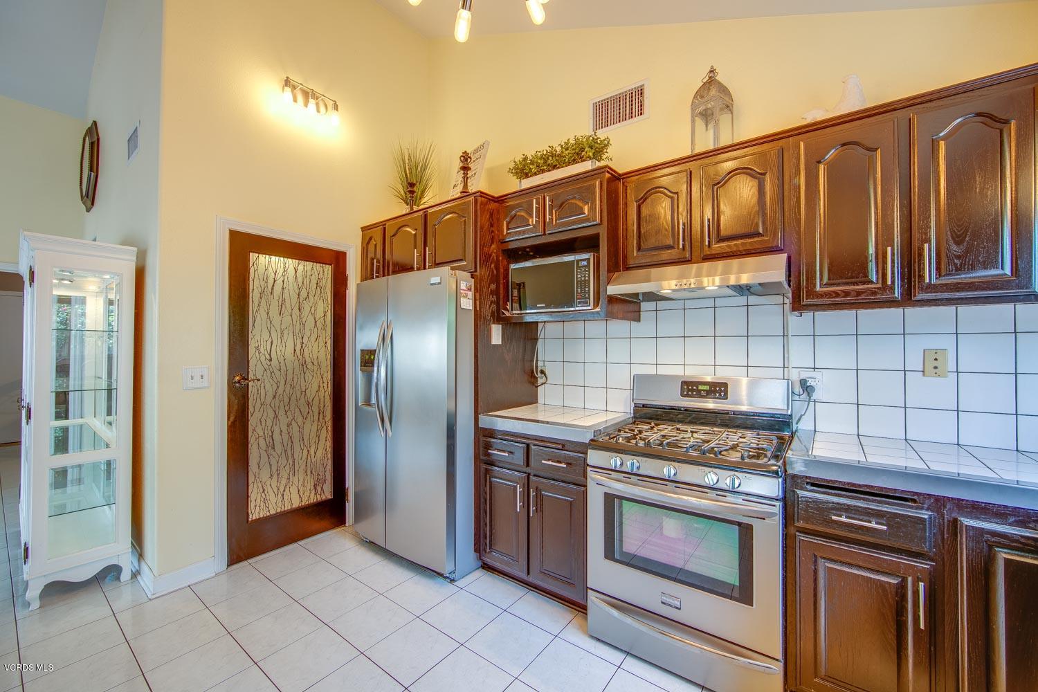 4265 Apricot Road Simi Valley, CA 93063 - Photo 14 of 39 a kitchen with stainless steel appliances granite countertop a stove and a refrigerator