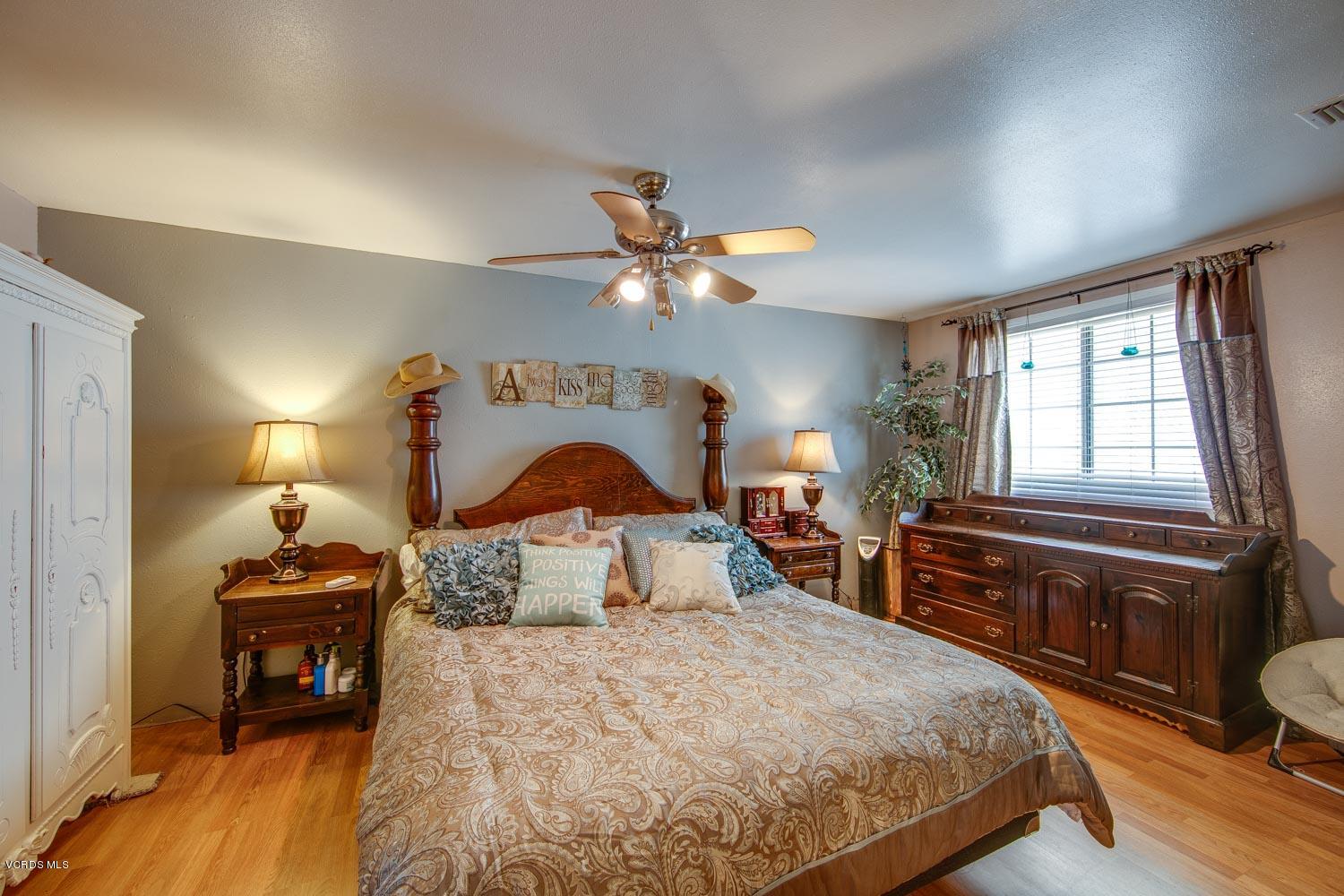 4265 Apricot Road Simi Valley, CA 93063 - Photo 19 of 39 a bedroom with a bed and wooden floor