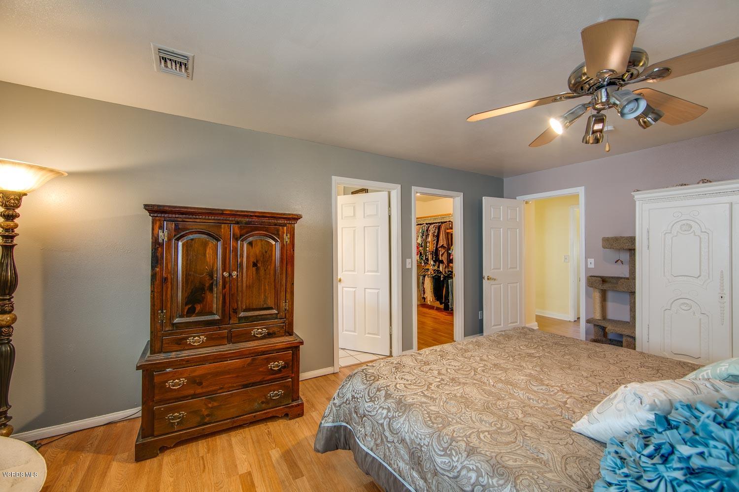 4265 Apricot Road Simi Valley, CA 93063 - Photo 20 of 39 a bedroom with a bed and a chandelier