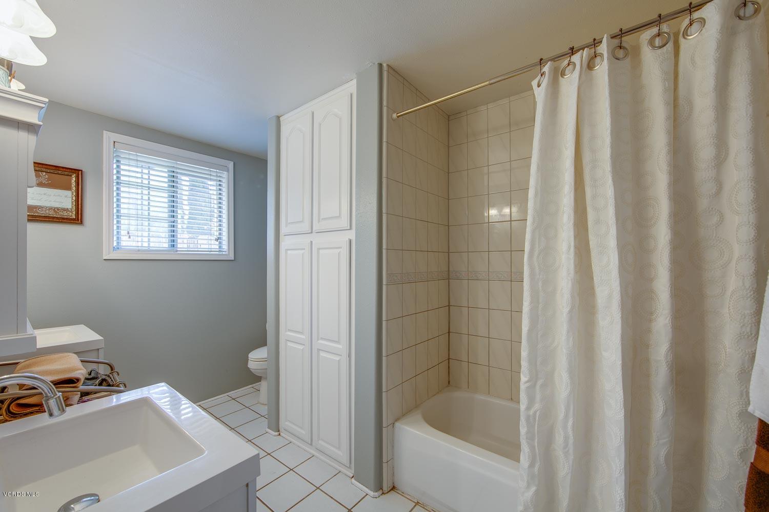 4265 Apricot Road Simi Valley, CA 93063 - Photo 21 of 39 a bathroom with a shower curtain and a sink