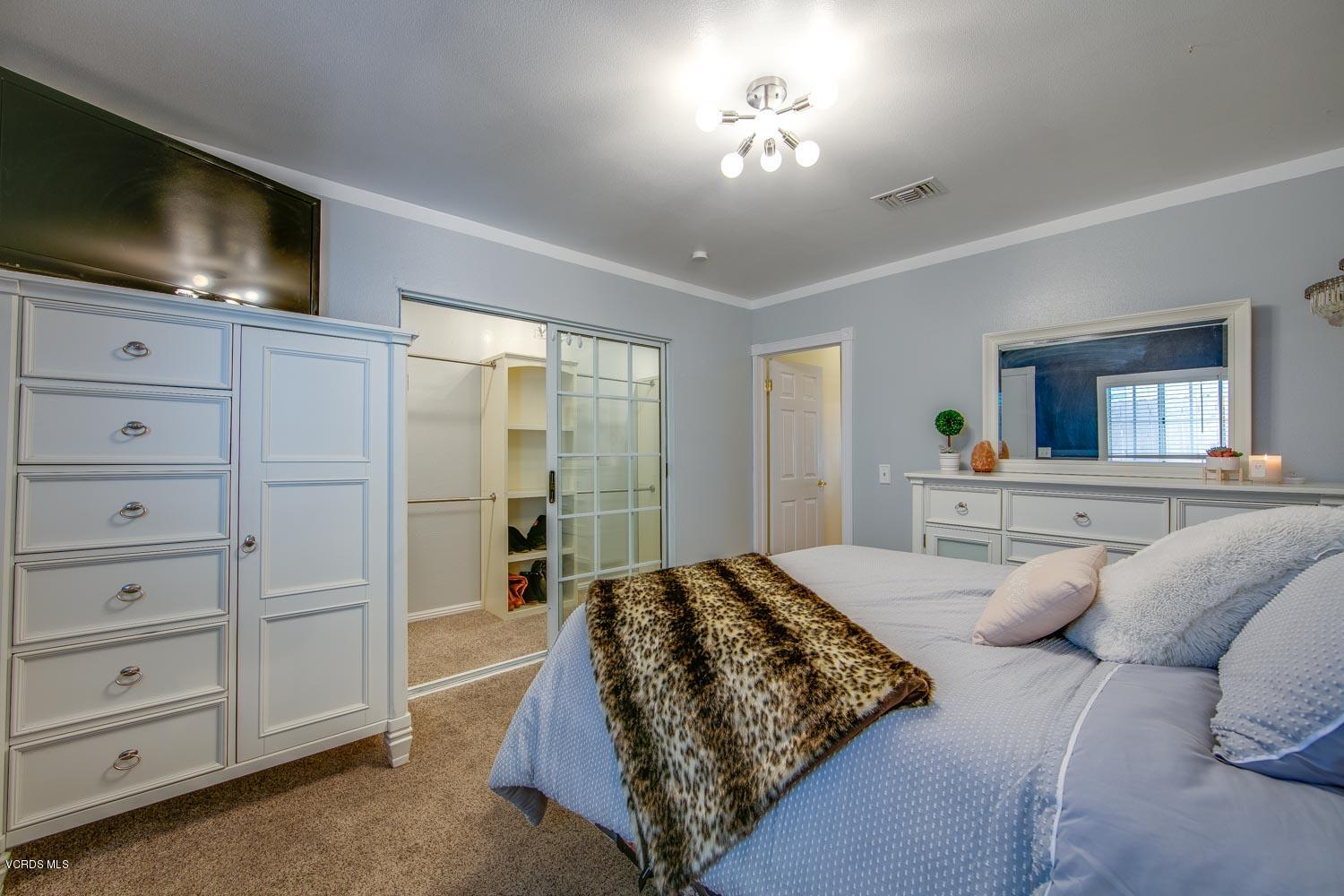 4265 Apricot Road Simi Valley, CA 93063 - Photo 24 of 39 a bedroom with a bed and a flat screen tv