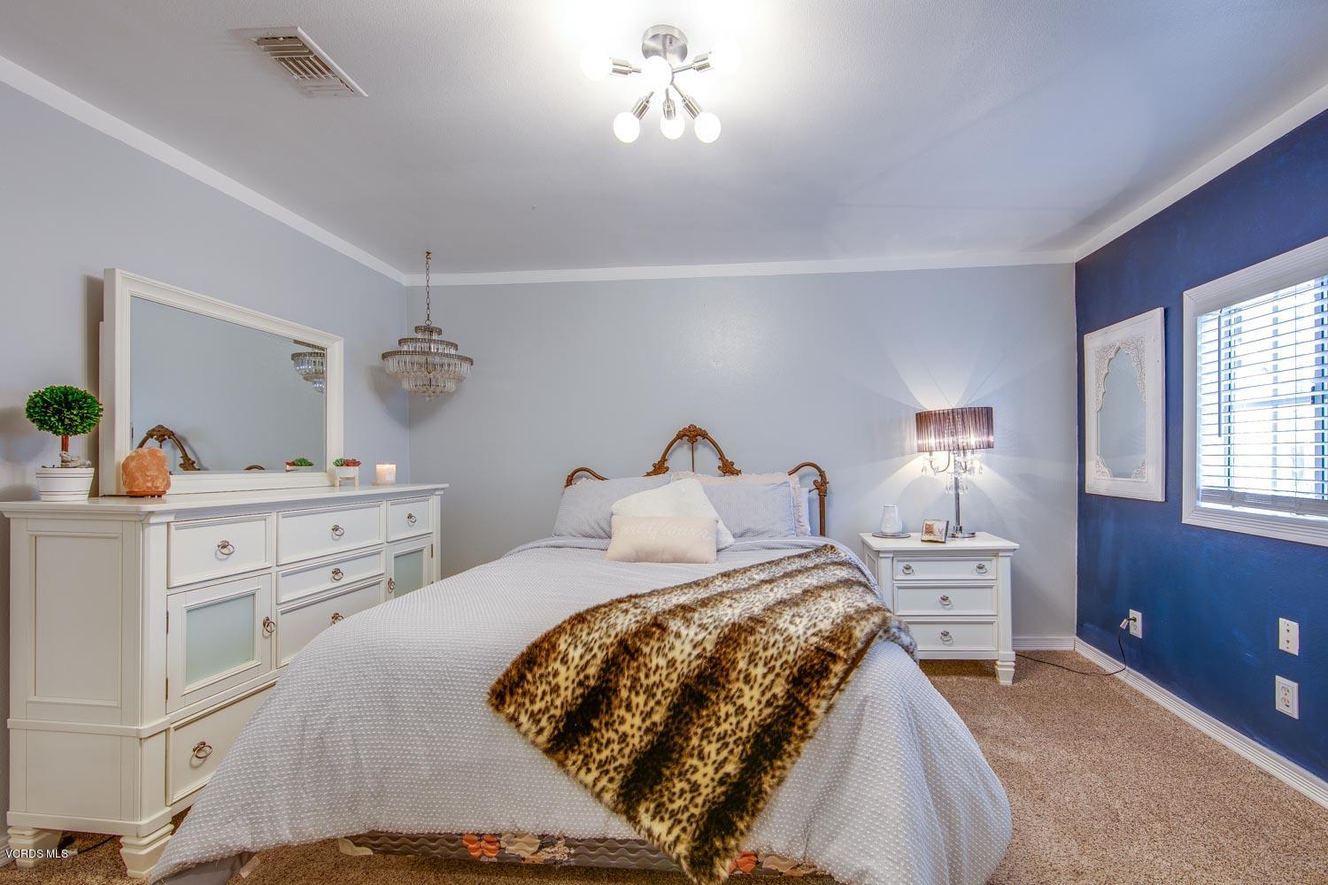 4265 Apricot Road Simi Valley, CA 93063 - Photo 25 of 39 a bedroom with a bed and a table lamp