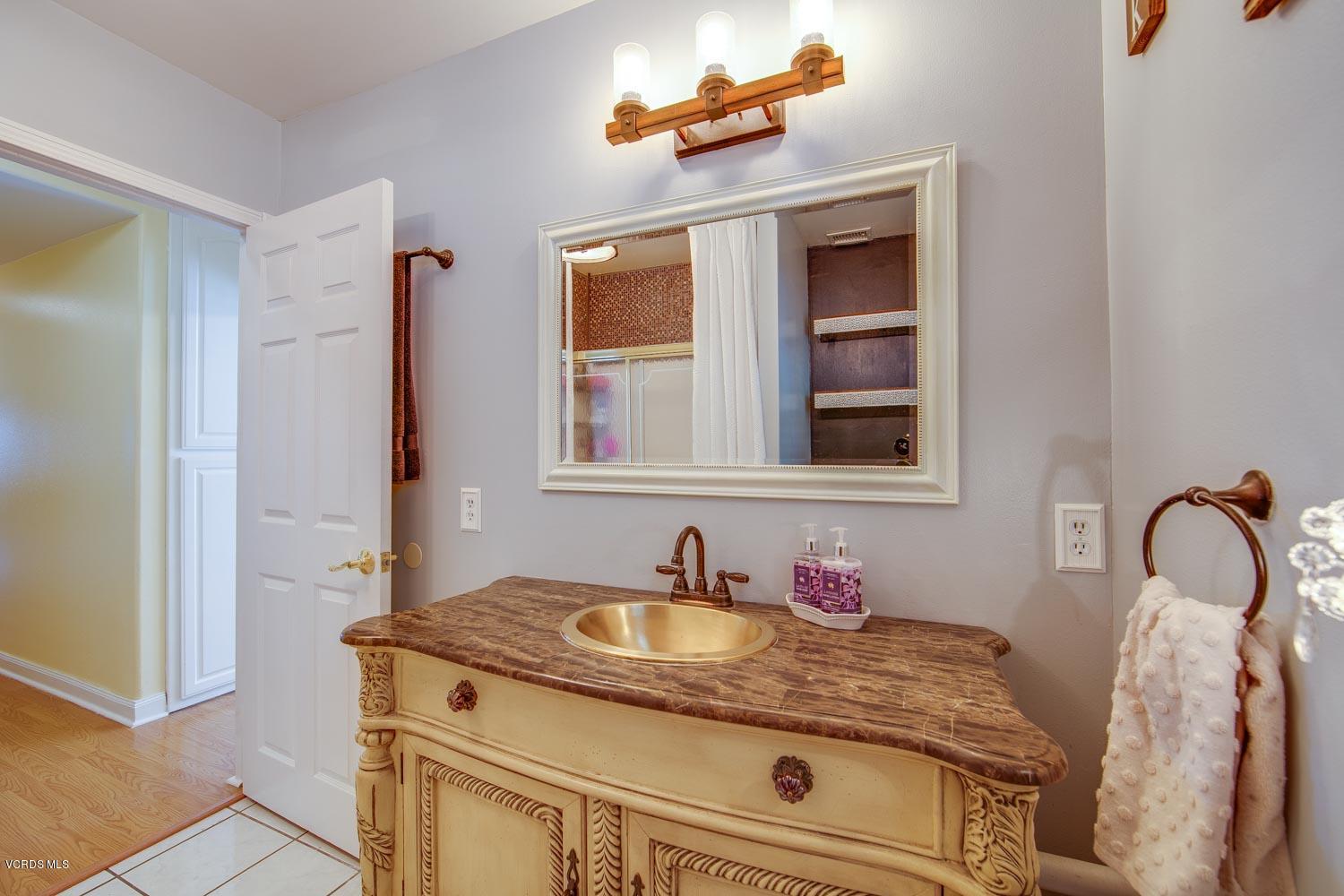 4265 Apricot Road Simi Valley, CA 93063 - Photo 27 of 39 a bathroom with a granite countertop sink and a mirror